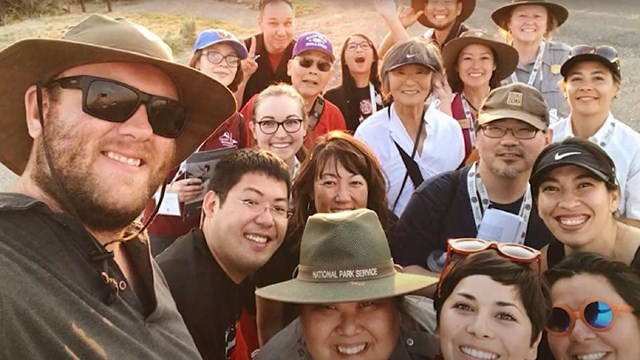 Ranger and group of visitors posing for a selfie 