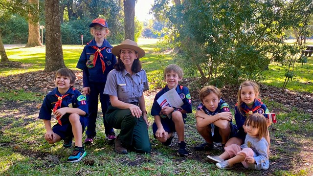 A scout troop listens to a Ranger talk about historic resources