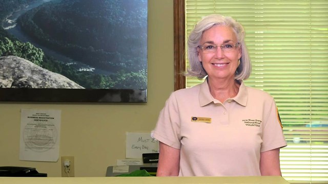 volunteer behind a visitor center desk