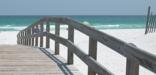 Beach walkway to white sandy beach and bluegreen waters