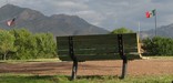 Bench with a view of the U.S. and Mexican flags