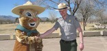 Chami, the park's mascot, receives a warm welcome by one of the park's rangers.