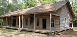 A rough hewn log cabin at Mission Tejas State Historic Park in Texas