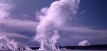 Winter scenic view of geyser erupting.