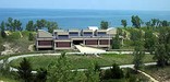 looking from top of a dune down on large building with circle drive in front and the beach and lake michigan in the back