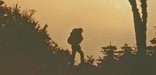Backpacker silhouetted against the setting sun.