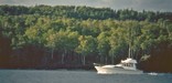 A boat travels down the Rock Harbor Channel.