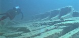 A scuba diver moves over on of the ten major shipwrecks on the Island.