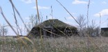 Earthlodge view through grass