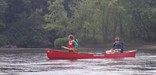 Two people in a canoe on the Mississippi River.