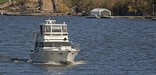 A power boat motors its way up the Mississippi River.