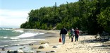 Visitors to Pictured Rocks National Lakeshore enjoy the beautiful beaches of Lake Superior as the waves roll gently in.