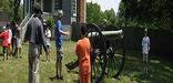Kids learning the steps and teamwork that it takes to fire a Civil War cannon.