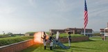 Fort McHenry Guard fires the fort's morning gun.
