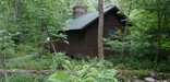The Prime Minister's Cabin, in historic Rapidan Camp, is nestled in the summer green of the forest.
