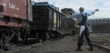 One of Steamtown's volunteers signals the engineer to stop as a gondola and caboose are coupled.  NPS Photo, Ken Ganz