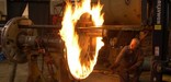Workers at Steamtown use heat to expand a steel tire and place it on a locomotive wheel. NPS Photo, Bill Clark