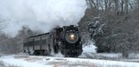 A steam locomotive pulls a passenger train during a winter excursion. NPS Photo, Ken Ganz