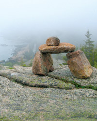 Four rocks create a Bate cairn, perched on a mountain over the Park Loop Road