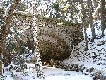 Cobblestone-covered bridge during the winter