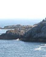 Cliffs on Isle au Haut rise high over the sea.