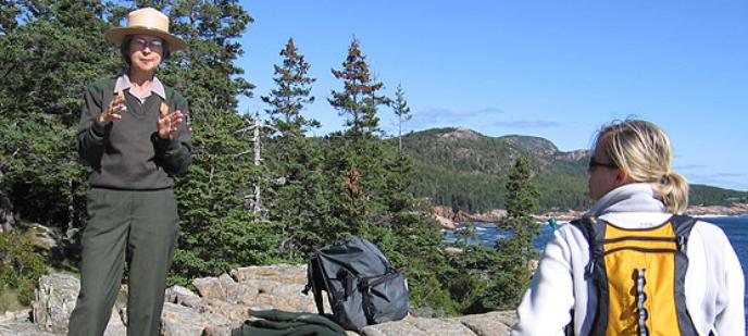 Woman listens to park ranger.
