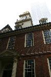 A modern building looms over the Old State House