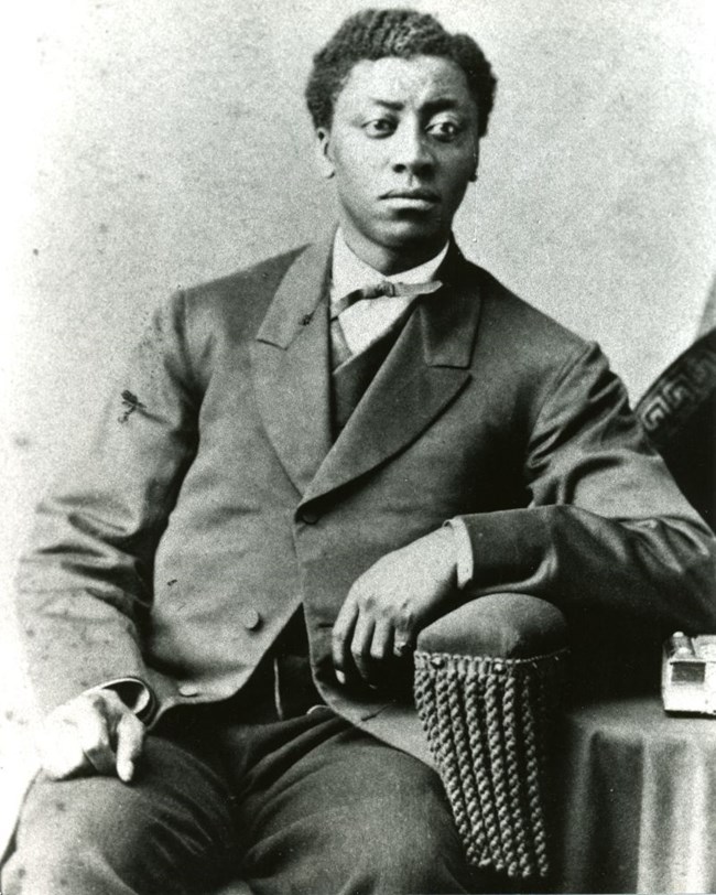 Black and white photo of Frederick Douglass, Jr seated