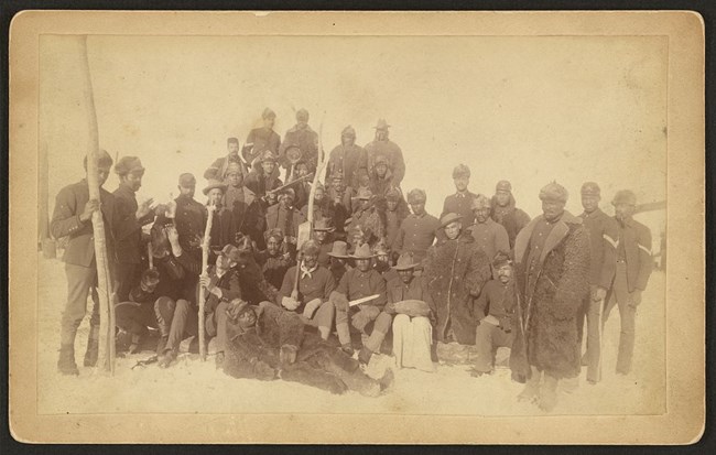 Buffalo soldiers of the 25th Infantry, some wearing buffalo robes. (Fort Keogh, Montana)