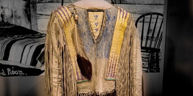 Yellow and blue lakota shirt in a display