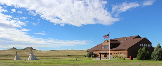 Agate Fossil Beds Visitor Center with Fossil Hills and tipis.