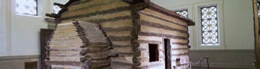 Picture of the symbolic cabin inside the Memorial Building once thought to be the birth cabin of Abraham Lincoln