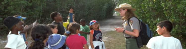 Picture of children with a ranger learning about nature and the parks