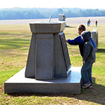 Students examine a historic monument