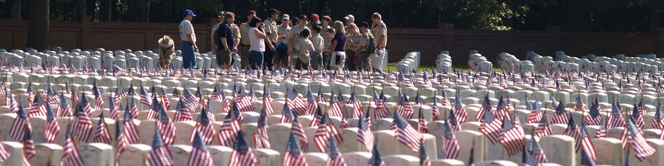Boy Scout volunteers placing flags in the Andersonville National Cemetery for Memorial Day