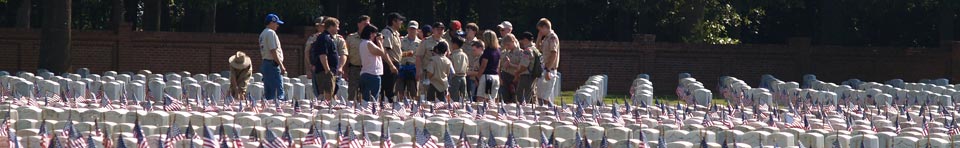 Boy Scout volunteers placing flags in the Andersonville National Cemetery for Memorial Day