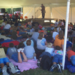 Storyteller entertaining visitors under the big tent.