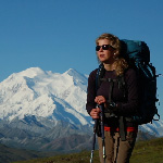 Woman wearing backpack with Denali in background