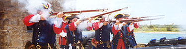 Re-enactors portraying Spanish soldiers fire their muskets at Fort Matanzas