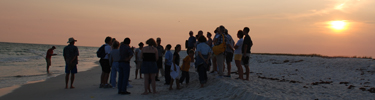 Visitors enjoy a sunset stroll with a ranger.