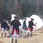 Reenactors firing the 3-pounder 