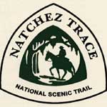 natchez trace national scenic trail logo with a man on a horse in the center of a triangular shaped logo