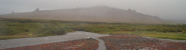 Fog on the mountains and steam coming from the river near Serpetine Hot Springs, Bering Land Bridge National Preserve.