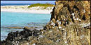 Black and white rock layers along the shoreline Black and white rock layers along the shoreline