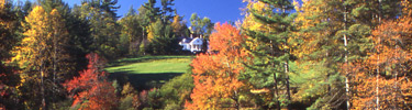 View of Sandburg home on hill as seen from the front lake in autumn