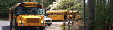 school busses in parking lot after a full day of education programs and hiking
