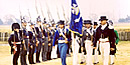 Men dressed as 1815 soldiers march across Chalmette Battlefield. Men dressed as 1815 soldiers march across Chalmette Battlefield.