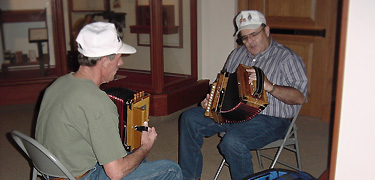 Volunteers at the Acadian Cultural Center sit down with their accordions and play a tune.