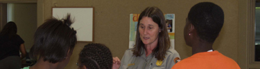 Superintendent Lizzie Watts talks with youth volunteers at Boys & Girls Club