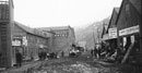 Univ. of Washington historic photo showing old street scene with mud streets and tightly packed businesses Univ. of Washington historic photo showing old street scene with mud streets and tightly packed businesses